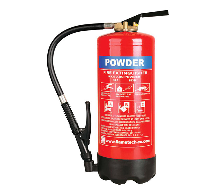 Selection of portable DCP and CO2 fire extinguishers mounted on a commercial office wall in Nairobi, Kenya