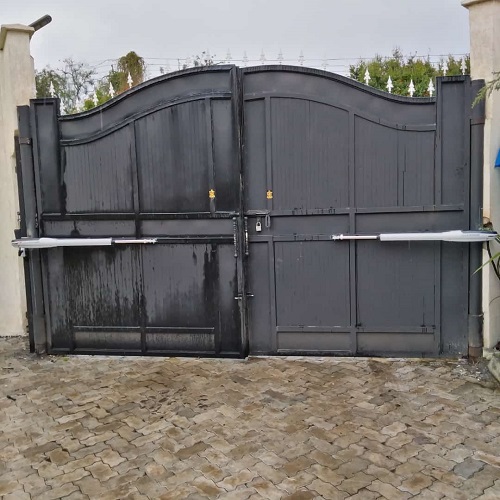 Modern electric sliding gate opening automatically for a vehicle at a residential property in Nairobi, Kenya